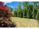 Expansive backyard featuring lush lawn and mature trees, creating a serene and private outdoor space at 3024 Eamont Ter, Atlanta, GA 30328