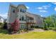 Backyard featuring lush green grass, well-maintained landscaping, and a cozy screened porch with a wood beam at 3024 Eamont Ter, Atlanta, GA 30328