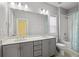 Bathroom featuring double vanity, framed mirror, and tub with tiled shower surround at 3024 Eamont Ter, Atlanta, GA 30328