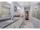 Modern bathroom featuring double sinks, marble floors, and a glass enclosed shower at 3024 Eamont Ter, Atlanta, GA 30328