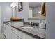 Bright bathroom features dual sinks, gray countertop, and white cabinets at 3024 Eamont Ter, Atlanta, GA 30328