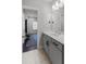 Cozy bathroom with gray vanity, white quartz countertop, and tile flooring leading to the adjacent exercise room at 3024 Eamont Ter, Atlanta, GA 30328