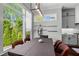 Dining room with large windows, pendant lighting, dark wood table and comfortable upholstered chairs and view to kitchen at 3024 Eamont Ter, Atlanta, GA 30328