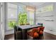 Modern dining room with large windows, modern light fixture, dark wood table and comfortable upholstered chairs at 3024 Eamont Ter, Atlanta, GA 30328