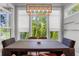 Modern dining room with large windows, pendant lighting, dark wood table and comfortable upholstered chairs at 3024 Eamont Ter, Atlanta, GA 30328