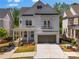 Charming two-story home featuring a covered front porch, a small balcony, and an attached two-car garage at 3024 Eamont Ter, Atlanta, GA 30328