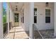 Inviting front porch with brick flooring, white columns, and a charming entrance at 3024 Eamont Ter, Atlanta, GA 30328