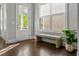 Entryway featuring hardwood floors, white trim, and a woven bench with a plant in decorative pot at 3024 Eamont Ter, Atlanta, GA 30328