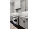 Modern kitchen features gray cabinets, quartz countertop, and stainless steel range hood and oven at 3024 Eamont Ter, Atlanta, GA 30328