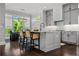 Modern kitchen with gray cabinets, hardwood floors, a center island, and a dining area overlooking the backyard at 3024 Eamont Ter, Atlanta, GA 30328