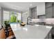 Bright kitchen with gray cabinets, island with sink, stainless appliances and breakfast bar with comfortable seating at 3024 Eamont Ter, Atlanta, GA 30328