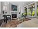 A sunlit living room featuring a marble fireplace and refined furnishings, providing a warm and inviting atmosphere at 3024 Eamont Ter, Atlanta, GA 30328