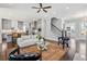Spacious living room seamlessly connecting to the kitchen with hardwood floors and staircase, creating an inviting space at 3024 Eamont Ter, Atlanta, GA 30328