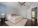 Sun filled main bedroom features an accent wall, ceiling fan, and a doorway to the hallway at 3024 Eamont Ter, Atlanta, GA 30328
