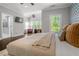 Sunlit main bedroom with seating area, ensuite bathroom and elegant decor at 3024 Eamont Ter, Atlanta, GA 30328