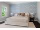 Bright main bedroom featuring a large window and a stylish accent wall with geometric patterns at 3024 Eamont Ter, Atlanta, GA 30328