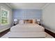 Spacious main bedroom with elegant accent wall, plush bedding, and lots of natural light at 3024 Eamont Ter, Atlanta, GA 30328