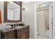 Elegant bathroom features a wooden vanity with a granite countertop and a framed mirror at 3127 Lenox Ne Rd # 20, Atlanta, GA 30324