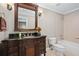 Bathroom with a wooden vanity, black granite countertop, large mirror, and a tub shower combo at 3127 Lenox Ne Rd # 20, Atlanta, GA 30324
