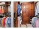 The walk-in closet features wood cabinets, custom shelves, hanging racks, and ample space for shoes and clothes at 3127 Lenox Ne Rd # 20, Atlanta, GA 30324
