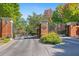 Gated community entrance with brick pillars, iron gates, and mature landscaping at 3127 Lenox Ne Rd # 20, Atlanta, GA 30324