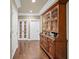 Hallway with hardwood floors, a built-in hutch and two sets of double doors leading into another room at 3127 Lenox Ne Rd # 20, Atlanta, GA 30324