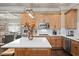Bright kitchen boasts stainless steel appliances, light wood cabinets, and a large island with white countertop at 3127 Lenox Ne Rd # 20, Atlanta, GA 30324