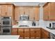 Kitchen showcasing stainless steel appliances, wooden cabinets, white countertops and backsplash, and gas cooktop at 3127 Lenox Ne Rd # 20, Atlanta, GA 30324