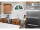 Kitchen featuring stainless steel appliances, wooden cabinets, white countertops, and a window above the sink at 3127 Lenox Ne Rd # 20, Atlanta, GA 30324
