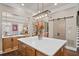 Kitchen view including an island with white countertops, barn doors, and a modern light fixture above the island at 3127 Lenox Ne Rd # 20, Atlanta, GA 30324