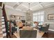 Bright living room featuring coffered ceiling, display shelving, and plantation shutters at 3127 Lenox Ne Rd # 20, Atlanta, GA 30324