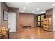 A brick-walled living room features hardwood floors, neutral walls, a custom wine cellar, and is freshly painted at 3127 Lenox Ne Rd # 20, Atlanta, GA 30324