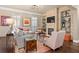 Living room featuring a stone fireplace, built-in shelves, a comfortable seating area, and dark hardwood floors at 3127 Lenox Ne Rd # 20, Atlanta, GA 30324