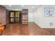 The open living room features brick walls, hardwood floors, a custom wine cellar, and neutral paint at 3127 Lenox Ne Rd # 20, Atlanta, GA 30324