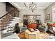 Sophisticated living room boasts a decorative chandelier and staircase with iron railing at 3127 Lenox Ne Rd # 20, Atlanta, GA 30324