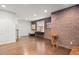 An open living room offers exposed brick, hardwood floors, neutral walls, a large window, and is freshly painted at 3127 Lenox Ne Rd # 20, Atlanta, GA 30324