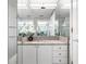 Bathroom with a granite countertop, a mirrored wall, and decorative floral accents at 3338 Peachtree Ne Rd # 3102, Atlanta, GA 30326