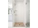 Modern bathroom with white tile and a frameless glass shower enclosure with modern shower fixtures at 3338 Peachtree Ne Rd # 3102, Atlanta, GA 30326