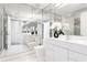 Modern bathroom with full mirrored walls, a white vessel sink, and white commode at 3338 Peachtree Ne Rd # 3102, Atlanta, GA 30326