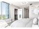 Bright bedroom with a cityscape view, showcasing a walk-in closet and modern chandelier at 3338 Peachtree Ne Rd # 3102, Atlanta, GA 30326