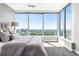 Sunlit bedroom with cityscape view, featuring a plush bed with a gray headboard and soft, neutral bedding at 3338 Peachtree Ne Rd # 3102, Atlanta, GA 30326