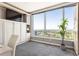 Bright bedroom with a Murphy bed, a large window providing scenic views, and custom cabinetry at 3338 Peachtree Ne Rd # 3102, Atlanta, GA 30326