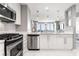 Modern kitchen features stainless steel appliances, white cabinetry, and pendant lighting above the sink at 3338 Peachtree Ne Rd # 3102, Atlanta, GA 30326