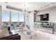 Living room with a large TV mounted on the wall, a mirrored console table, and floor-to-ceiling windows at 3338 Peachtree Ne Rd # 3102, Atlanta, GA 30326