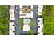 Aerial view of property featuring a central community pool, landscaping, and townhouse-style residences at 5105 Chemin De Vie, Atlanta, GA 30342