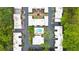 Aerial view of property featuring a central community pool, landscaping, and townhouse-style residences at 5105 Chemin De Vie, Atlanta, GA 30342