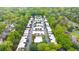 Aerial view of community featuring a pool, surrounded by trees and well-maintained townhouse-style homes at 5105 Chemin De Vie, Atlanta, GA 30342