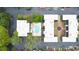 Aerial view of property featuring a central community pool, landscaping, and townhouse-style residences at 5105 Chemin De Vie, Atlanta, GA 30342