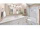 Bright bathroom with double sinks, tub, and white cabinets at 5105 Chemin De Vie, Atlanta, GA 30342