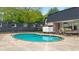 Relaxing community pool surrounded by tables and chairs offering a great spot to cool off at 5105 Chemin De Vie, Atlanta, GA 30342